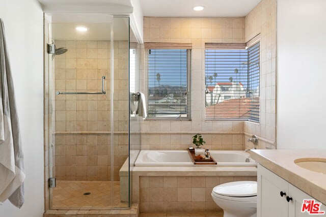 full bathroom with vanity, toilet, and separate shower and tub