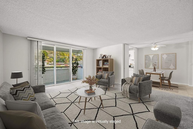 living room with a textured ceiling and ceiling fan