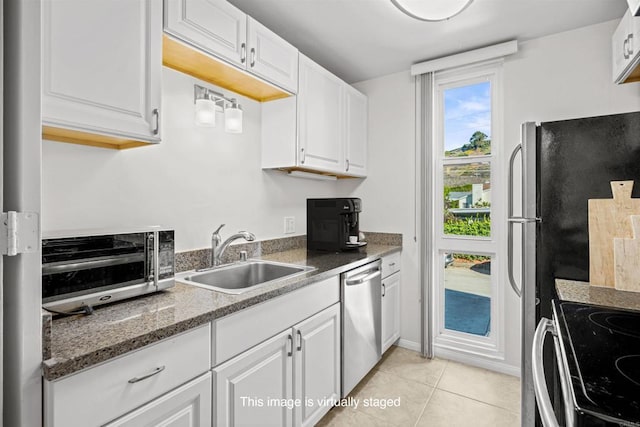 kitchen with a sink, white cabinetry, and stainless steel dishwasher