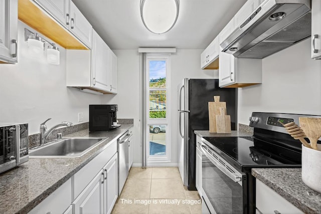 kitchen with light tile patterned floors, a sink, stainless steel appliances, under cabinet range hood, and white cabinetry