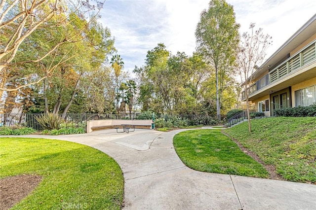 view of home's community featuring a yard and a patio