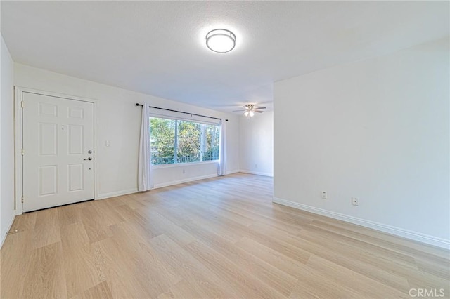 unfurnished room featuring ceiling fan and light wood-type flooring