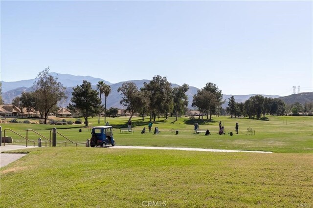 view of home's community featuring a mountain view and a lawn