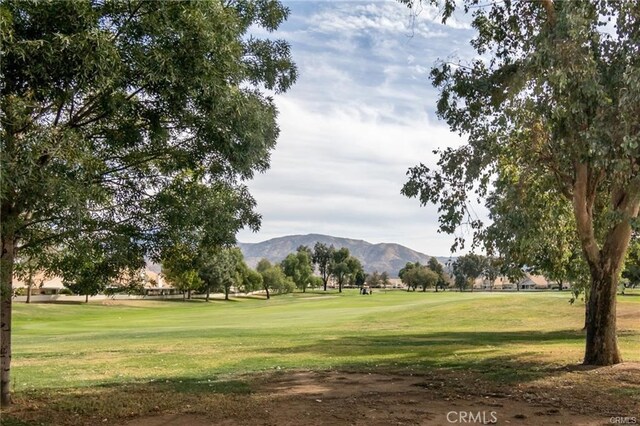 view of community with a mountain view and a lawn