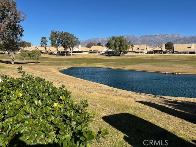 view of home's community featuring a water view and a yard