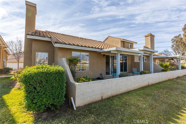 rear view of property with a yard