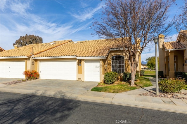 mediterranean / spanish-style house with a garage