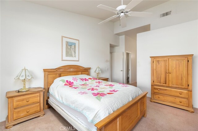 carpeted bedroom with ceiling fan and vaulted ceiling