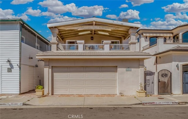 view of front of house featuring a balcony and a garage