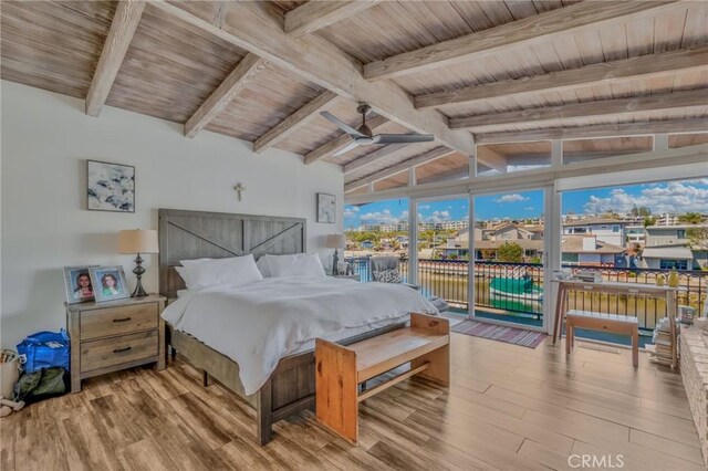 bedroom with access to outside, lofted ceiling with beams, wood ceiling, and light hardwood / wood-style flooring