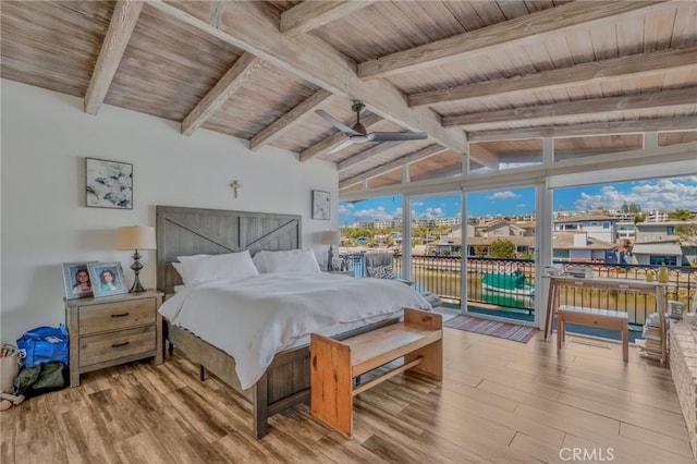 bedroom featuring access to exterior, vaulted ceiling with beams, wooden ceiling, and light hardwood / wood-style flooring