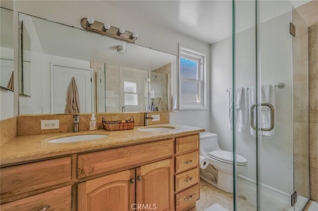 bathroom featuring walk in shower, vanity, and toilet