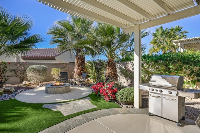 view of patio / terrace featuring an outdoor fire pit, grilling area, and a pergola