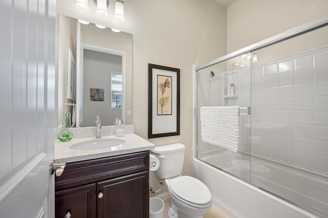 full bathroom featuring toilet, vanity, and enclosed tub / shower combo