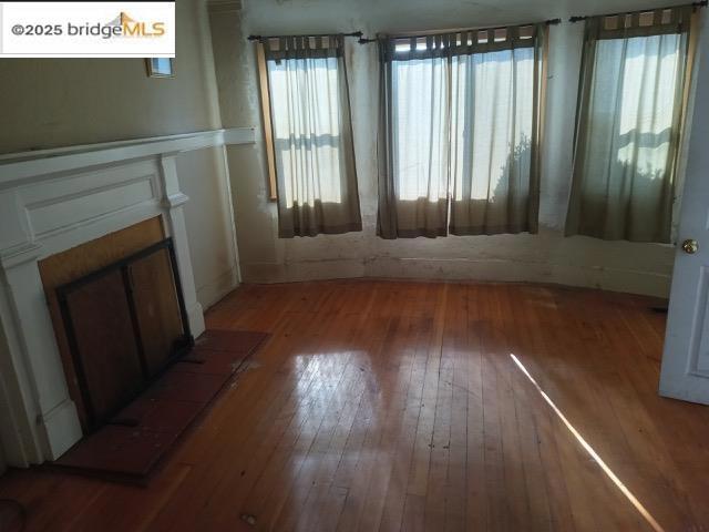 unfurnished living room featuring hardwood / wood-style floors