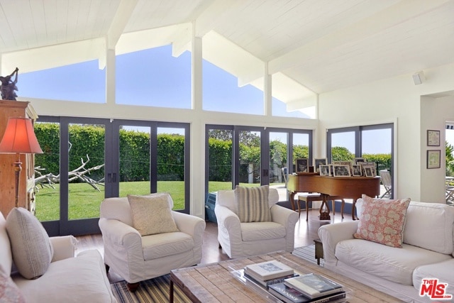 sunroom featuring french doors and lofted ceiling with beams