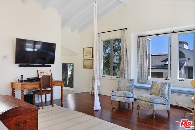 interior space featuring high vaulted ceiling, beam ceiling, and hardwood / wood-style floors