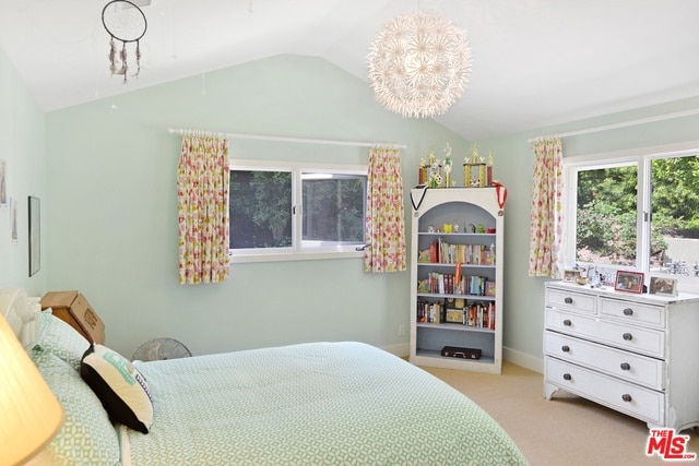 carpeted bedroom featuring vaulted ceiling