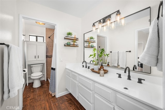 bathroom featuring toilet, hardwood / wood-style flooring, a shower with curtain, and vanity