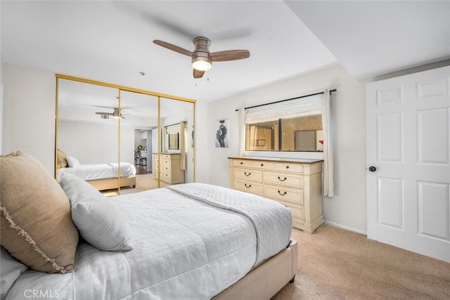 carpeted bedroom featuring ceiling fan and a closet