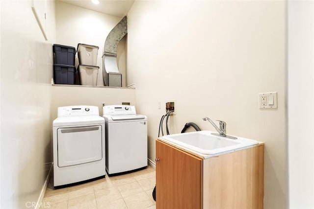 laundry room featuring sink, washing machine and dryer, and light tile patterned floors