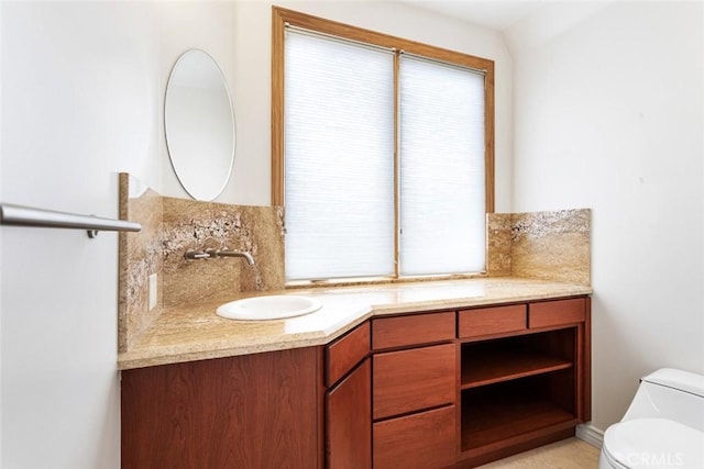 bathroom featuring backsplash, vanity, and toilet