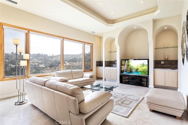 living room featuring a raised ceiling