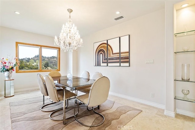 dining area featuring an inviting chandelier