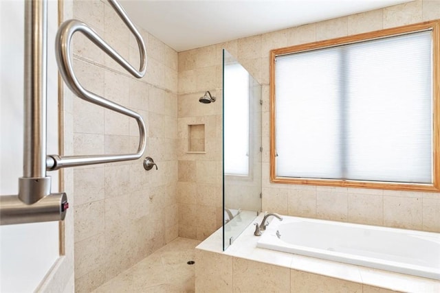 bathroom featuring separate shower and tub