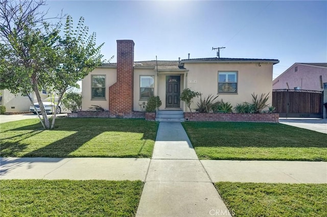 bungalow-style home with a front lawn