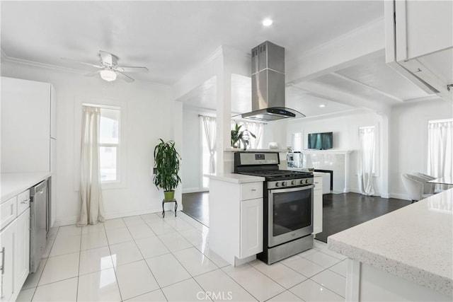 kitchen featuring white cabinetry, island exhaust hood, stainless steel appliances, ceiling fan, and light stone counters