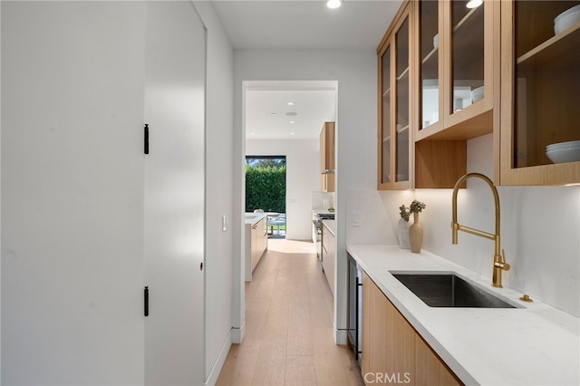 kitchen with brown cabinetry, recessed lighting, modern cabinets, and a sink
