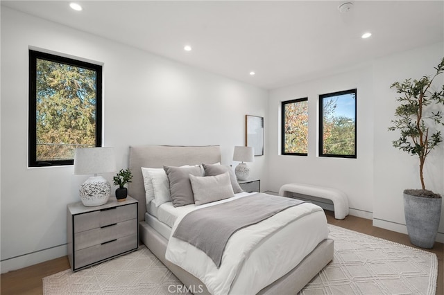 bedroom featuring baseboards, recessed lighting, and light wood-style floors