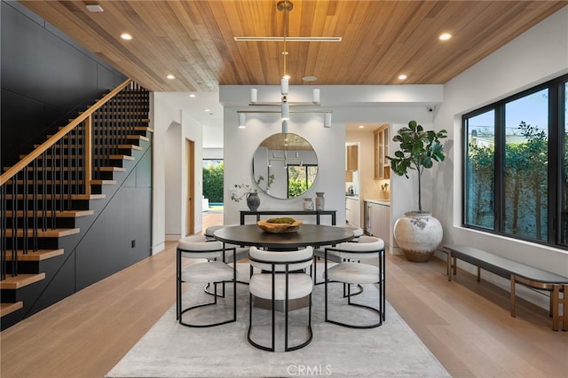 dining space with wooden ceiling, plenty of natural light, recessed lighting, light wood finished floors, and stairs