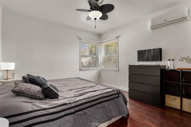 bedroom featuring dark hardwood / wood-style flooring, ceiling fan, and a wall mounted AC