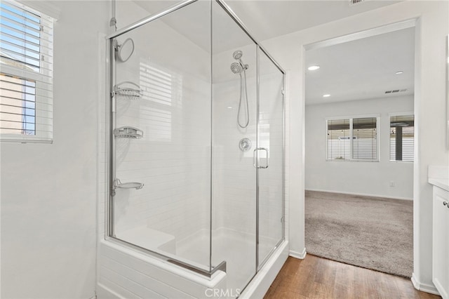 bathroom featuring vanity, hardwood / wood-style floors, and walk in shower