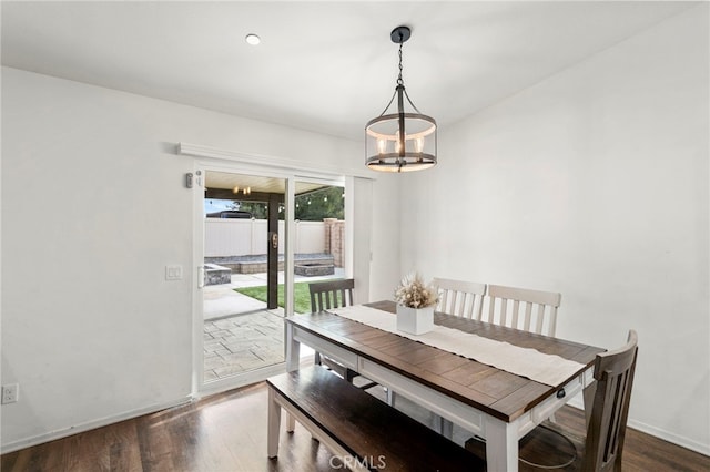 dining room featuring a notable chandelier and dark hardwood / wood-style flooring