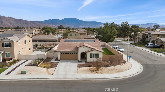 view of front of home with a garage and a mountain view