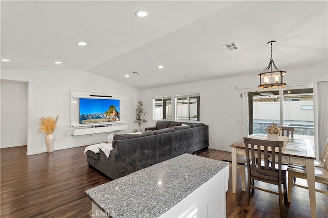 living room with dark wood-type flooring and vaulted ceiling