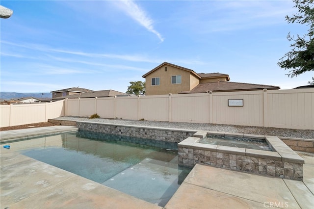 view of swimming pool with an in ground hot tub