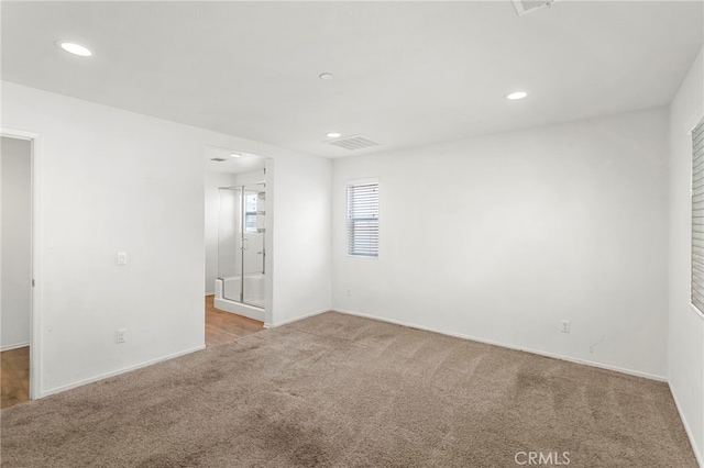 empty room featuring light carpet