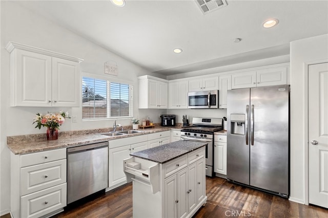 kitchen featuring white cabinetry, sink, a center island, and appliances with stainless steel finishes