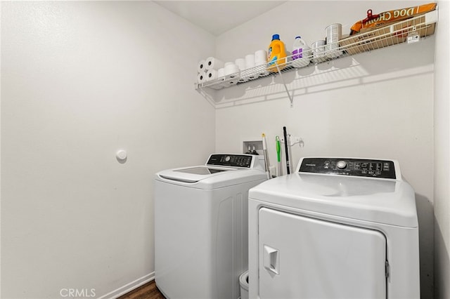 clothes washing area featuring washer and clothes dryer