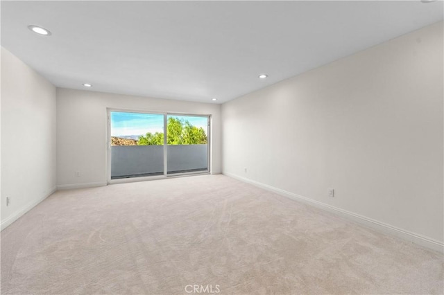 unfurnished room featuring light carpet