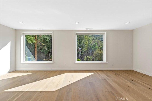 empty room with light hardwood / wood-style flooring