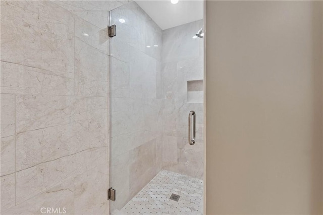 bathroom featuring a shower with shower door