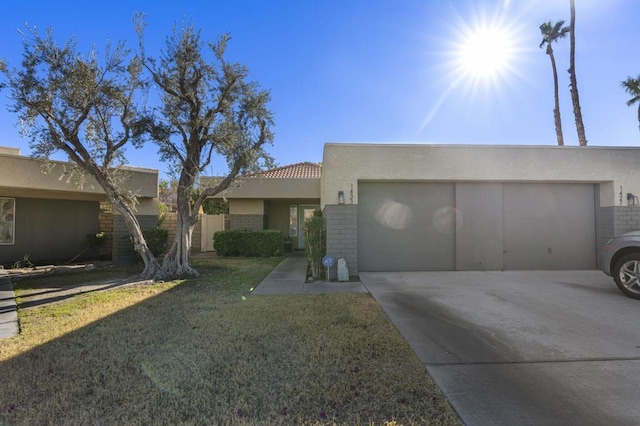 view of front of house with a front yard and a garage