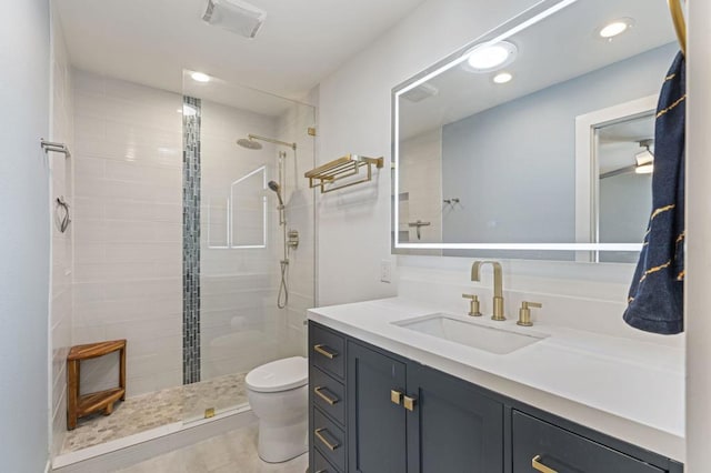 bathroom featuring toilet, a shower with door, and vanity