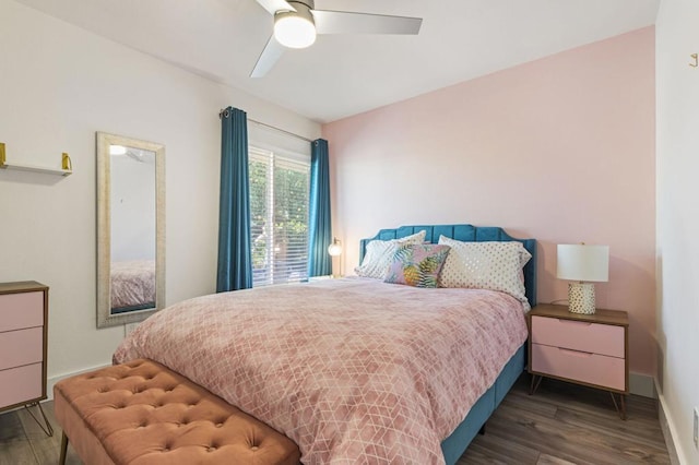 bedroom with dark hardwood / wood-style flooring and ceiling fan