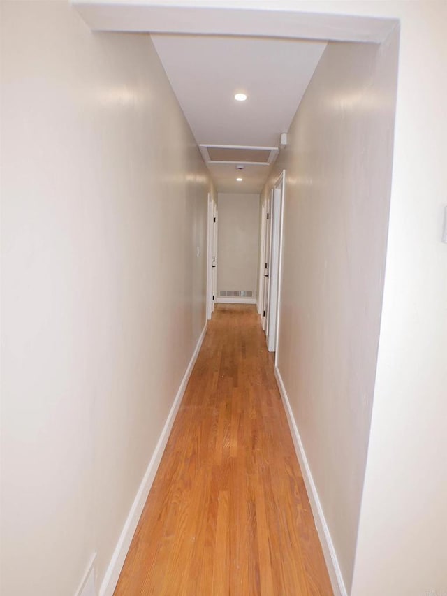 corridor with light wood-type flooring